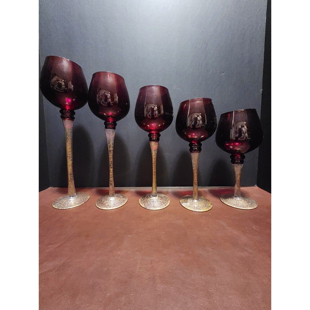 These Italian Venetian red and gold candle holders feature graduated heights and
